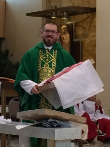 During Mass, Father John presented Adam with a gift from the parish -- a set of rose colored vestments for him and a deacon.  